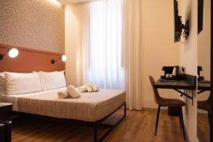 a hotel room with a bed and a desk with a computer at Residenza Leone XIII in Rome
