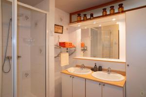 a bathroom with two sinks and a shower at La Pastorale in Manhay +30 photos