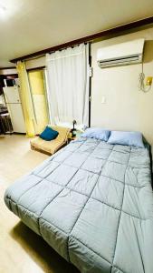 釜山Top Rated Cosy Gwangalli Room - 1 Min to Beach - Great Value的一间卧室配有一张蓝色的大床