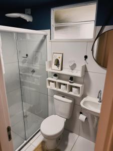 a small bathroom with a toilet and a shower at Apto Refúgio raiz in Santa Maria +8 photos