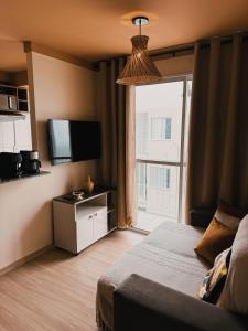 a hotel room with a bed and a large window at Apto Refúgio raiz in Santa Maria