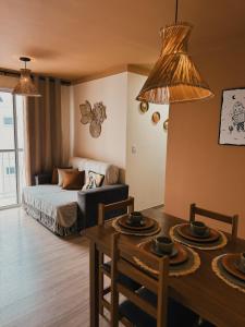 a living room with a bed and a dining room table at Apto Refúgio raiz in Santa Maria