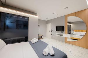 a bedroom with a large bed with two towels at Hotel Elite Sarande in Sarandë