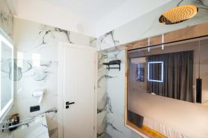 a bathroom with a shower and a mirror at Hotel Elite Sarande in Sarandë +213 photos