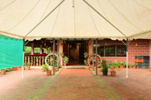 a large tent in front of a building with potted plants at DELIGHTFUL HOMESTAY in Sollebail