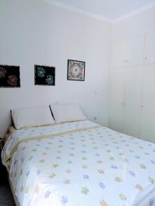 a bedroom with a bed with a comforter on it at Studio with cute garden space in Nydri +2 photos