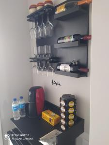 a kitchen with a shelf with pots and pans at Hospedagem Altas da Quitéria Suíte 02 in Catas Altas