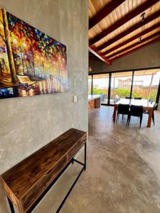 a living room with a large painting on the wall at La Morada Punta Sal - Casa de playa frente al mar in Canoas de Punta Sal