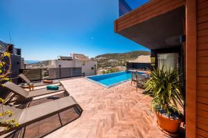a backyard with a swimming pool and a house at Villa Elmas in Kalkan