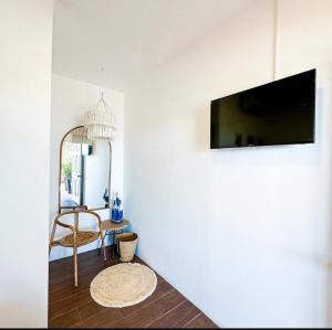 a living room with a flat screen tv on a wall at Barú in La Libertad