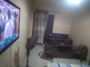 a living room with a large flat screen tv at Apparte in Dakar