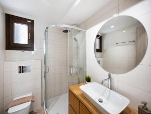 a bathroom with a sink and a shower and a mirror at G&S House in Tsoukalades +11 photos