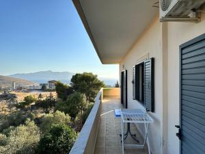 a balcony with a table on the side of a house at Green Garden Villa in Sarandë