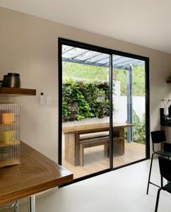 a kitchen with a sliding glass door with a garden outside at Madria Loft Cabin in Baras +15 photos