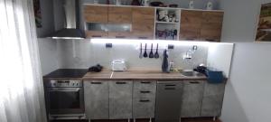 a kitchen with a wooden counter top and a sink at Къща за гости Балканъ in Kyustendil