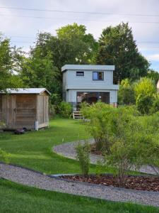 a house with a garden and a shed at L'Ecrin des Sentiers in La Bruyère