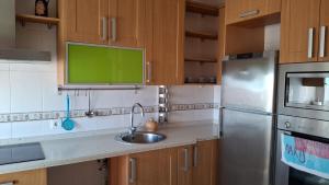 a kitchen with a sink and a refrigerator at La Vivienda de Morales in Morales del Vino