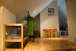 a living room with a green column and two tables at Apartment Arnika in Kořenov