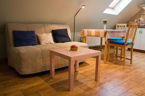 a living room with a couch and a table at Apartment Arnika in Kořenov