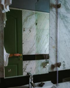 a bathroom with a green door and a mirror at Colonel’s Retreat in New Delhi +60 photos
