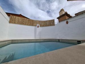 a swimming pool on the side of a building at Alquería de Tajarja in Tajarja