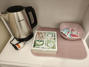 a coffee maker and a box of chocolates on a counter at Profumo di Langa in Narzole
