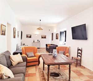 a living room with a couch and a table at Alquería de Tajarja in Tajarja