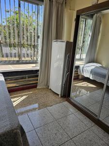 a room with a refrigerator next to a window at Studio Asa Sul 6 205 in Brasilia