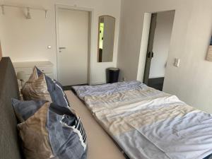 a bed in a room with two pillows at Urlaub in Horn in Horn +14 photos