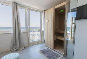 a bathroom with a large window with a view of the ocean at Three Room in Torre a Mare