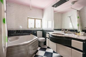 a bathroom with a tub and a sink and a toilet at Romano I megustarural in Porrúa +77 photos