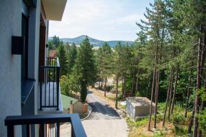 a balcony with a view of a road and trees at Panorama Tornik Zlatibor P4 apartman in Zlatibor