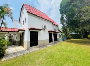 a white house with a red roof and a yard at Villa BABA D'FAMOSA - Homestay A'Famosa Private Pool Villa in Kampong Ulu Pegoh