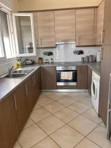 a kitchen with a sink and a stove at Latomi Sea View in Chios