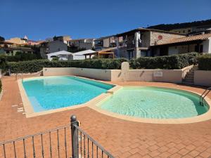 a large swimming pool on a red brickickedickedickedickedickedickedickedicked at Dimora degli ulivi in Badesi