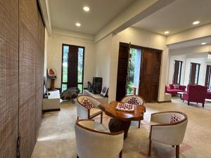 a living room with a table and chairs at Happiness Hill house in Rikillagaskada