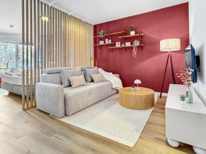 a living room with a couch and a table at Design-Apartment mit Meerblick in Travemünde