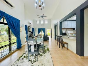 a dining room and kitchen with a table and chairs at Villa BABA D'FAMOSA - Homestay A'Famosa Private Pool Villa in Kampong Ulu Pegoh