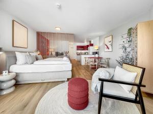 a living room with a bed and a couch at Design-Apartment mit Meerblick in Travemünde