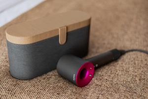 a black flashlight sitting on the floor next to a box at Hotel NANDANA in Diannan