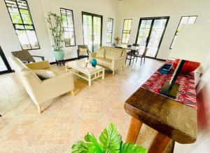 a living room with chairs and a table at Casa G Private BeachfrontYour own private beach in Samal