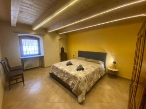 a bedroom with a large bed in a yellow room at Dai nonni in Aosta