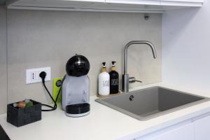 a kitchen counter with a mixer and a sink at LucAsia in Monopoli +12 photos