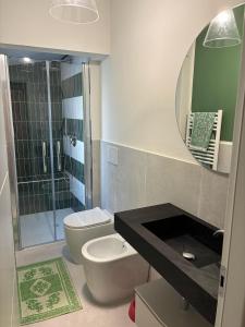a bathroom with a toilet and a sink and a mirror at I Fragoli a Sant'Ambrogio in Florence