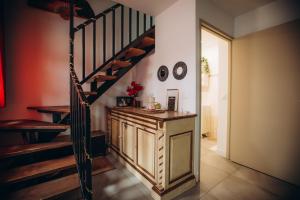 a hallway with a staircase and a room with a counter at Casa Di Vibes - Jacuzzi - Sauna in Saint-Maur-des-Fossés