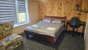 a bedroom with a bed and a chair and a desk at Green Hills Villa in Sakhnovka +55 photos