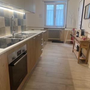 a kitchen with a sink and a stove top oven at Tirano center-325m dal Bernina Express in Tirano +7 photos