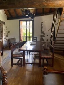 a dining room with a wooden table and chairs at Le refuge cerdan in Saint-Pierre-dels-Forcats +3 photos