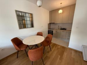 a kitchen with a table and chairs in a room at Apartmants City Love in Podgorica