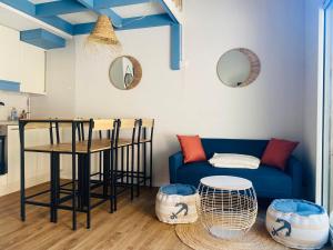 a living room with a blue couch and a table at Pavillon 4-6 couchages in Cap d'Agde